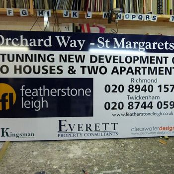 Featherstone Leigh advertising panel mounted on construction hoarding in  Orchard Way - St Margarets, Twickenham